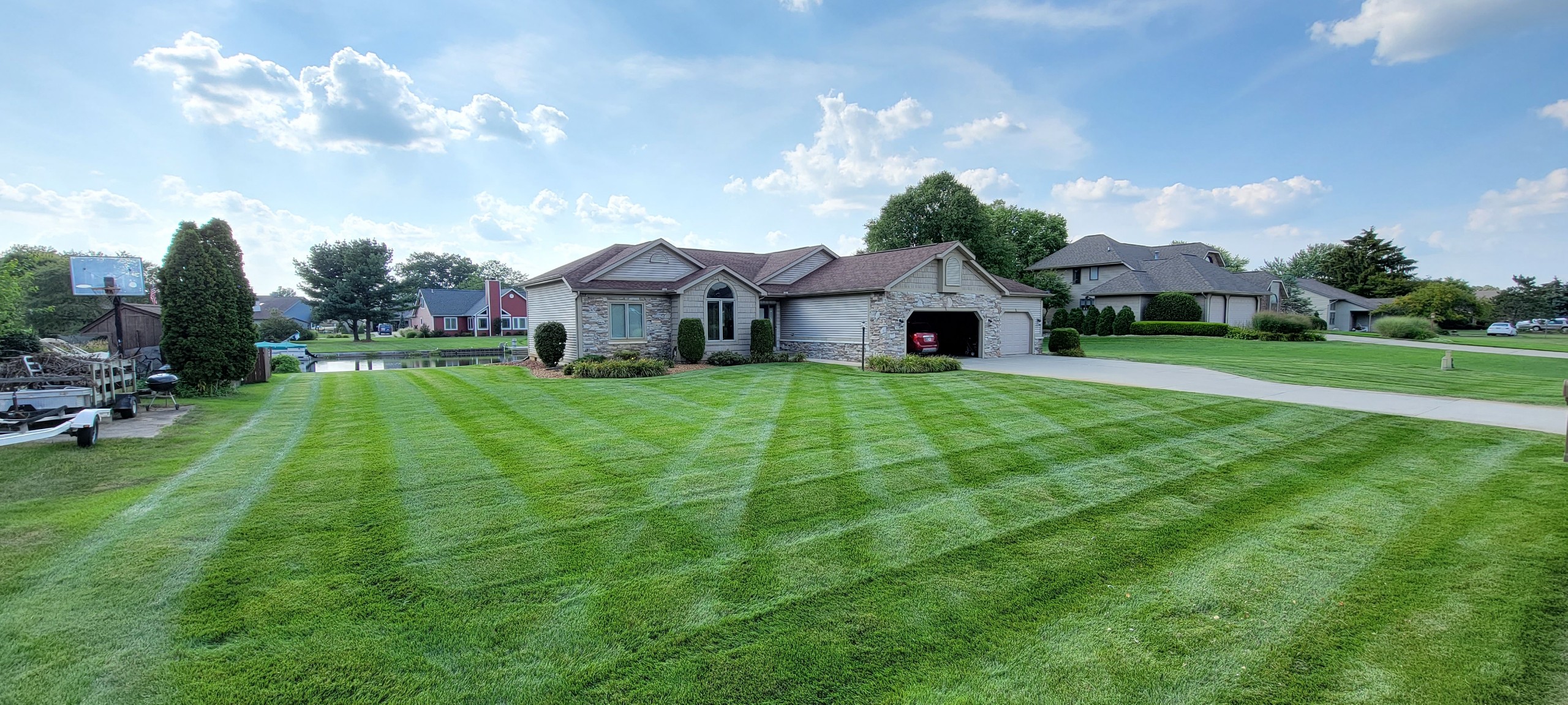Front view of home and freshly mowed front lawn with mowing stripes in Granger, IN 