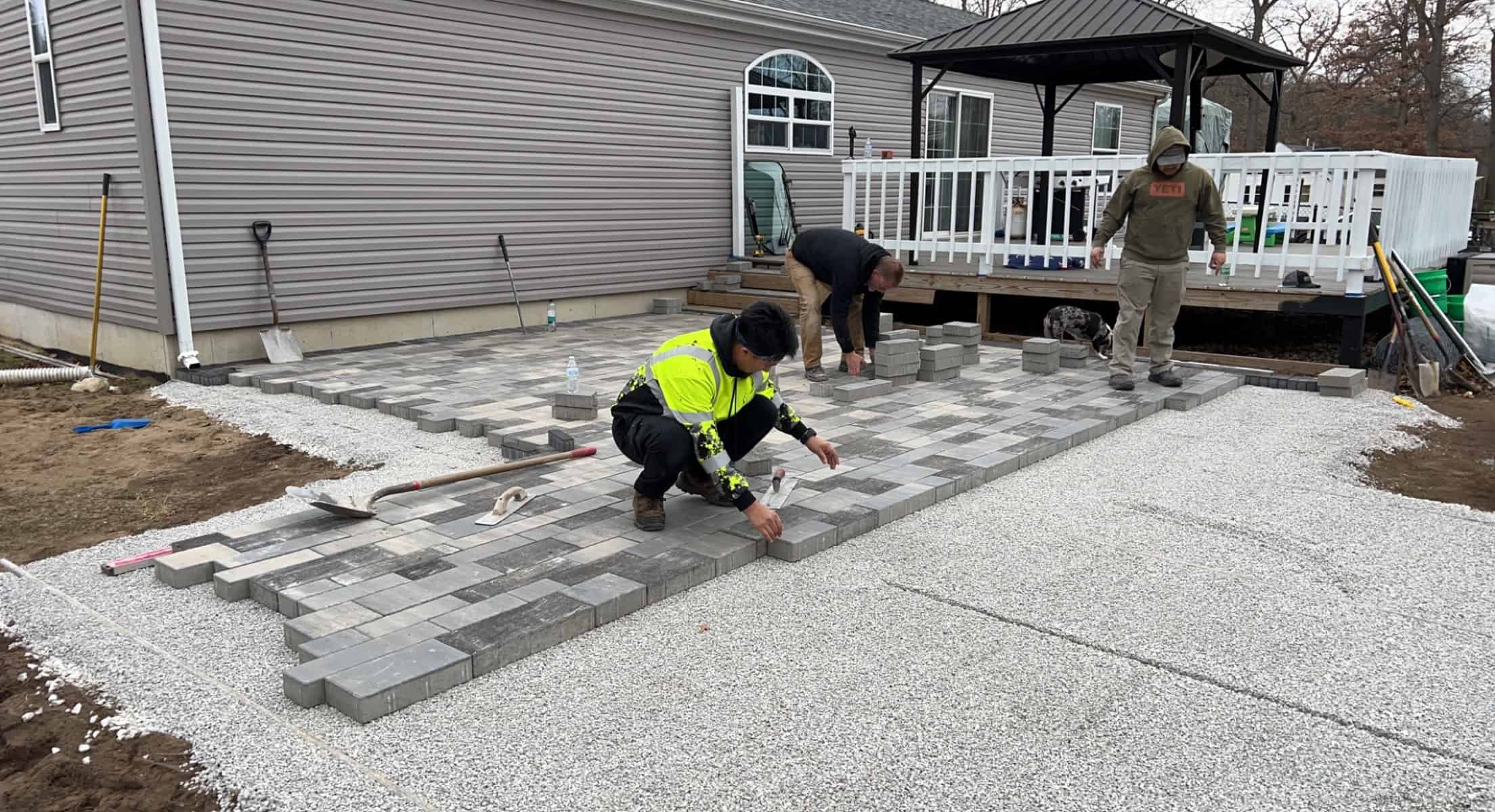 Busy Lil’ Beaver workers working hard to lay down the perfect paver patio.