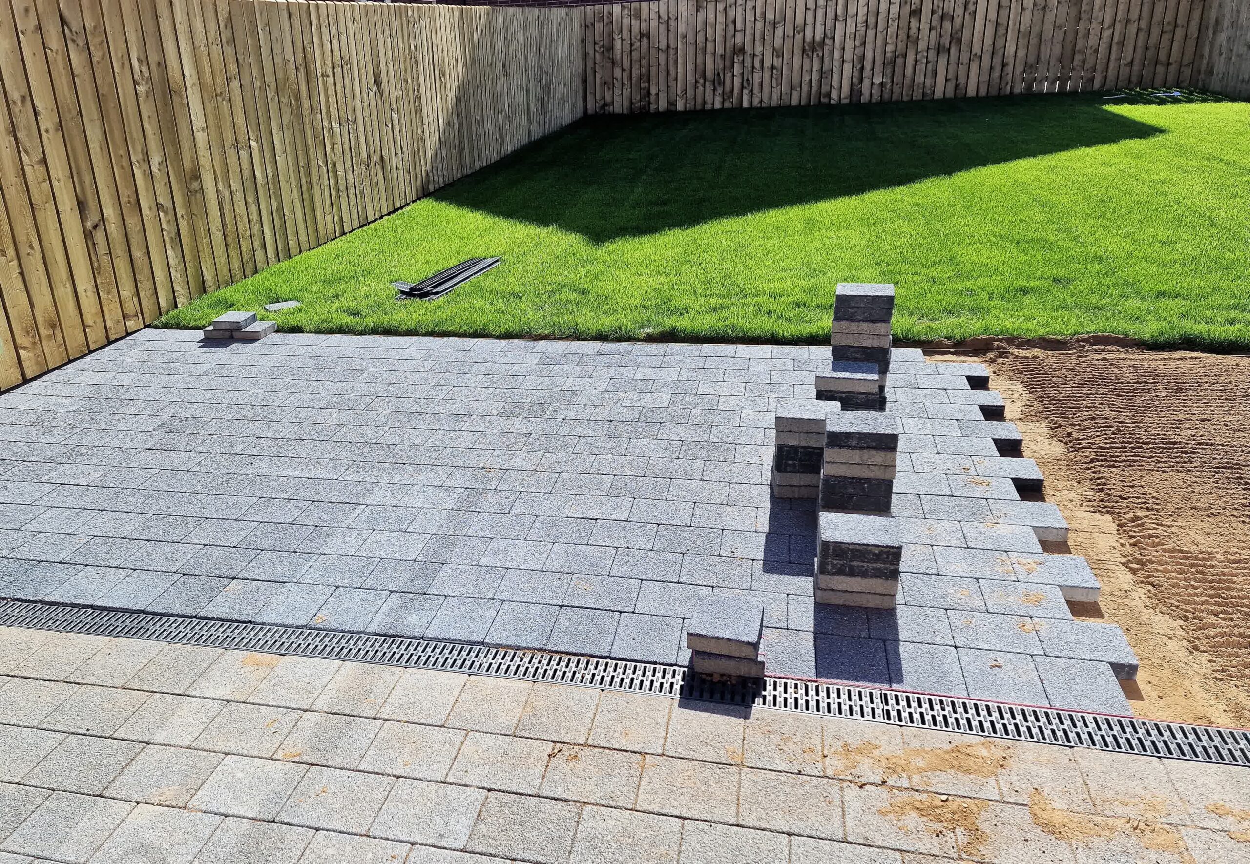 A paver patio under professional construction.